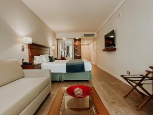 a hotel room with a bed and a couch at Blank Hotel Recoleta in Buenos Aires