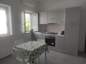 a kitchen with a table with a table cloth on it at Cirella House in Cirella