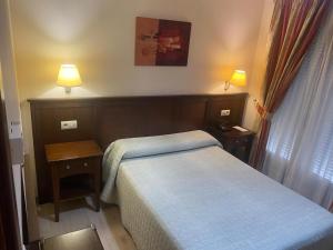 Posteľ alebo postele v izbe v ubytovaní Hostal Carmen