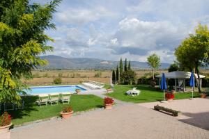 a resort with a swimming pool and a garden at Villa Ludovica by Mmega in Cortona