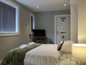 a bedroom with a bed with towels on it at Teviot View in Hawick