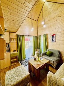 a living room with a couch and a table at Luxurious Cottages in Batumi with a Pool in Batumi +52 photos