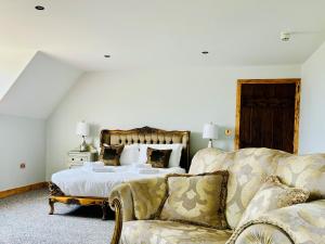 a bedroom with a bed and a couch at Sneaton Castle in Whitby