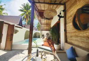 an external view of a villa with a swimming pool at Kaleydo Villas in Gili Trawangan