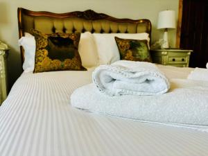 a white towel sitting on top of a bed at Sneaton Castle in Whitby