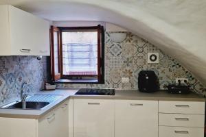 a kitchen with a sink and a window at cami sea apartment in Meta