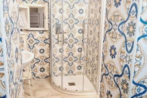 a bathroom with blue and white walls and a sink at cami sea apartment in Meta +9 photos