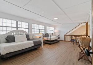 a bedroom with two beds and a staircase with windows at Reflection Bay in Winchester