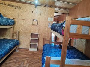 a room with two bunk beds in a house at Soraypampa Hostel - Private Cabins & Dorms for Self-Guided Humantay & Salkantay Trek -Comidas-hot shower-wifi-Pack horses in Salcantay