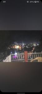 a view of a city at night with lights at Hotel NainKaran Tourist Lodge And Restaurant in Uttarkāshi