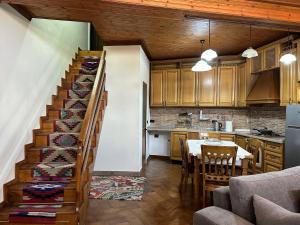 a kitchen and dining room with a staircase in a house at Old Bazaar House in Krujë