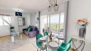 a living room with a dining table and green chairs at Casa Egeo R - Murcia Holiday Rentals Property in Sucina