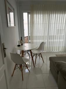 a dining table and chairs in a living room at Casa con terraza en La Plazuela in Arrecife +6 photos