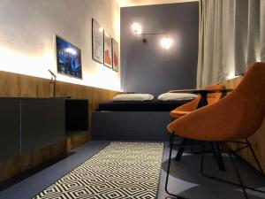 a room with a bed and a table and a chair at Bratislava center - blue apartment in Bratislava