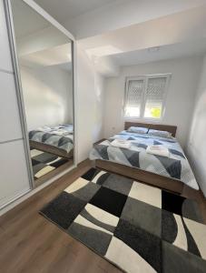 a bedroom with a bed and a mirror at Downtown Great Apartment in Strumica +9 photos
