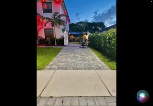 a walkway in front of a pink house at Tropical Studio in Miami