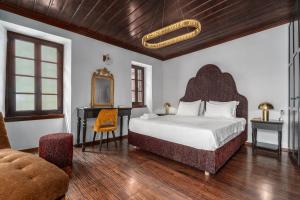 a bedroom with a bed and a desk and a chair at Telegraphus Boutique Home in Skiathos