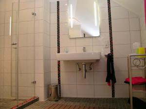 a bathroom with a sink and a mirror at Ferienwohnung Am Dom in Xanten +8 photos