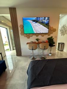 a living room with a flat screen tv on the wall at Tropical Studio in Miami