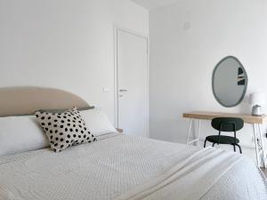 a bedroom with a bed with a mirror and a table at Casa dei Sogni in Scalea
