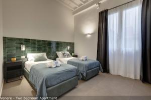 Posteľ alebo postele v izbe v ubytovaní Venere & Zefiro Apartments by Mamo Florence