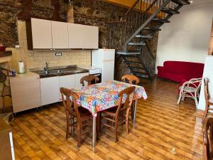a kitchen with a table and chairs and a staircase at Bed & Breakfast Casa Galeano in Pizzo