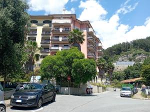 a car parked in a parking lot in front of a building at Oly Dolce Casa by Holiday World in Cogoleto