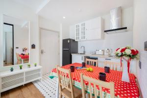 a kitchen with a table with a red and white table cloth at The Halo 1 Naiyang Beach in Nai Yang Beach