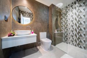 a bathroom with a toilet and a sink and a mirror at The Halo 1 Naiyang Beach in Nai Yang Beach +156 photos