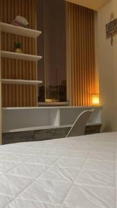 a bedroom with a white bed and a window at Sai in Lima +5 photos