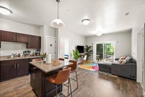 an open kitchen and living room with a couch at Stylish Apartment Close to Attractions in Salt Lake City