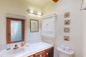 a bathroom with a sink and a toilet and a mirror at Casa De Lorena in Santa Fe +27 photos