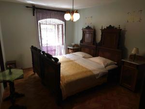 a bedroom with a large bed and a window at Guesthouse Kuća na šterne in Lovran