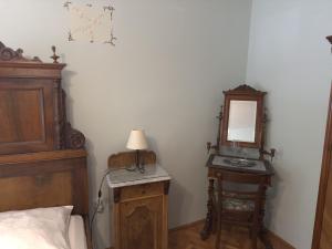 a bedroom with a bed and a vanity and a mirror at Guesthouse Kuća na šterne in Lovran +15 photos