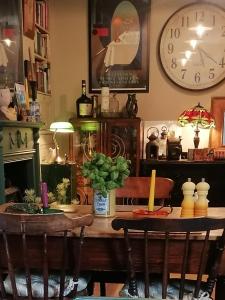 a dining room with a table and a clock on the wall at No 30 Guest House, Aberdare in Aberdare