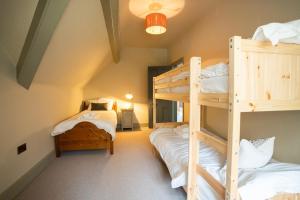 a room with two bunk beds and a ladder at Haulfryn in Barmouth