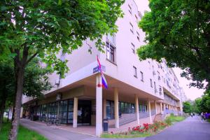 a building with a flag in front of it at Aurea Apartment Zagreb West in Zagreb