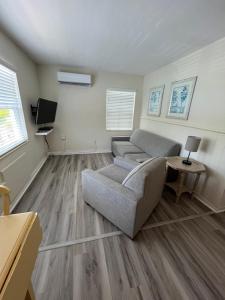 a living room with a couch and a tv at Venice Beach Villas in Venice