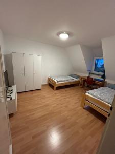 a room with two beds and a room with a table at Ferienwohnung an der Messe in Hannover