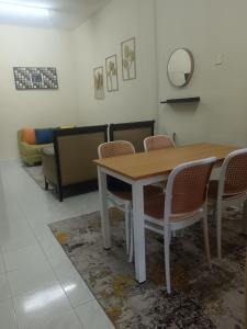a dining room with a table and chairs at Madana homestay pasir puteh in Pasir Puteh