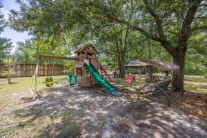 a playground with a slide and a swing at Hamilton Home Playground 2BR in Lexington
