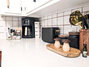 a kitchen counter with two vases on a cutting board at The Tiki Suite 2BR 2BA in Columbia