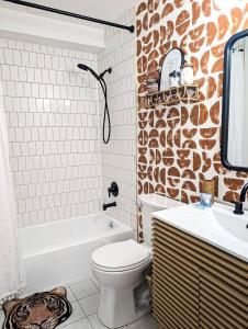 a bathroom with a white toilet and a sink at The Tiki Suite 2BR 2BA in Columbia