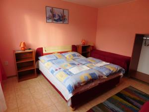 a bedroom with a bed with a colorful comforter at Apartmany Tania in Závažná Poruba