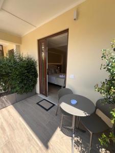 a patio with a table and chairs and a bed at Residenza Gurnea - Free Private Parking in Tropea