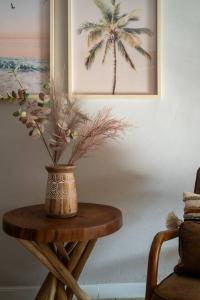 a wooden table with a vase on top of it at Ocean Home Sweet Home - Suite 1 in Rosarito