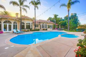 a home with a swimming pool and palm trees at Poway Villa - Private Resort in Poway