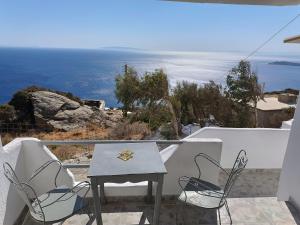 a table and chairs on a balcony overlooking the ocean at Silver View Aprovato in Apróvaton