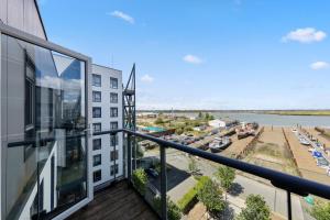a balcony of a building with a view of a river at Luxury 1 Bedroom flat by the water with allocated parking in Hoo