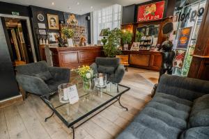 a waiting room with couches and a table in a store at Brueghel in Lille